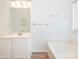Well-lit bathroom with white vanity, soaking tub, and modern fixtures at 6212 Derryfield Dr, Charlotte, NC 28213