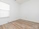 Bright bedroom with wood-look flooring, bathed in natural light, a perfect space for rest and rejuvenation at 6212 Derryfield Dr, Charlotte, NC 28213