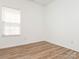 Bedroom with wood-look flooring, bright natural light, and ample open space at 6212 Derryfield Dr, Charlotte, NC 28213