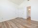 A bright bedroom with a glimpse into a bathroom space and modern vinyl flooring at 6212 Derryfield Dr, Charlotte, NC 28213