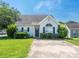 Traditional-style home with manicured shrubs and a clean, inviting facade at 6212 Derryfield Dr, Charlotte, NC 28213