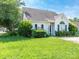A well-manicured front yard with lush landscaping enhancing a light grey home's curb appeal at 6212 Derryfield Dr, Charlotte, NC 28213