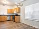 Kitchen featuring wooden cabinets, stainless appliances, and bright natural lighting at 6212 Derryfield Dr, Charlotte, NC 28213