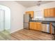 Updated kitchen with stainless steel appliances, wood cabinetry, and modern flooring at 6212 Derryfield Dr, Charlotte, NC 28213