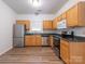 Well-equipped kitchen with stainless steel appliances, granite countertops, and wood cabinetry at 6212 Derryfield Dr, Charlotte, NC 28213
