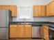 Kitchen featuring stainless steel appliances, wood cabinets, and modern faucet at 6212 Derryfield Dr, Charlotte, NC 28213