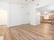 Open-concept living space with wood floors leading to a modern kitchen at 6212 Derryfield Dr, Charlotte, NC 28213