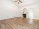 Bright living room featuring high ceilings, fireplace, and durable wood-look flooring at 6212 Derryfield Dr, Charlotte, NC 28213
