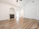 A bright living room with vaulted ceilings, fireplace, and wood-look floors at 6212 Derryfield Dr, Charlotte, NC 28213