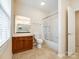 Well-lit bathroom with a shower-tub combo, toilet and vanity with a large mirror at 720 Kingsmill Ln, Clover, SC 29710