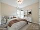 Bright bedroom featuring neutral walls, two windows, carpeted floors and modern decor at 720 Kingsmill Ln, Clover, SC 29710