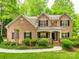 Beautiful brick two-story home featuring well-maintained landscaping and classic black shutters at 720 Kingsmill Ln, Clover, SC 29710