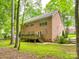 Brick home featuring a wooden deck, mature trees, and a well-maintained lawn at 720 Kingsmill Ln, Clover, SC 29710