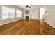 Bright living room features a fireplace, built-in shelving, hardwood floors, and large windows at 720 Kingsmill Ln, Clover, SC 29710