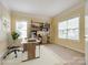 Bright office space with neutral carpet, natural light, built-in shelving, and a modern desk at 720 Kingsmill Ln, Clover, SC 29710