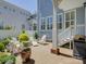 Back patio with white Adirondack seating, lush greenery, and a grilling area at 757 Shady Grove Xing, Fort Mill, SC 29708