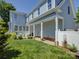 Spacious backyard with a brick patio, covered porch and meticulously manicured lawn at 757 Shady Grove Xing, Fort Mill, SC 29708