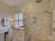 Luxurious bathroom featuring a glass enclosed shower, marble countertops, and a vanity area at 757 Shady Grove Xing, Fort Mill, SC 29708
