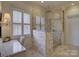 Luxurious bathroom featuring a glass enclosed shower, marble countertops, and a vanity area at 757 Shady Grove Xing, Fort Mill, SC 29708