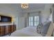 Elegant bedroom featuring a chandelier, tray ceilings, window with light and airy curtains at 757 Shady Grove Xing, Fort Mill, SC 29708