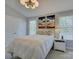 Bright bedroom featuring a white bed, nightstand, and a modern light fixture at 757 Shady Grove Xing, Fort Mill, SC 29708