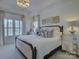 Elegant bedroom with tray ceilings, chandelier, decorative pillows, and lots of natural light at 757 Shady Grove Xing, Fort Mill, SC 29708