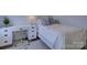 Bright bedroom featuring a white bed frame, desk, and soft blue pillows at 757 Shady Grove Xing, Fort Mill, SC 29708