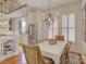 Light and airy dining room adjacent to the kitchen with a view of the living area and window shutters at 757 Shady Grove Xing, Fort Mill, SC 29708