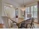 Bright dining area featuring a wooden table, chandelier, and large windows with natural light at 757 Shady Grove Xing, Fort Mill, SC 29708