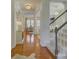 Bright foyer with hardwood floors, elegant chandeliers, and an open view into the living spaces at 757 Shady Grove Xing, Fort Mill, SC 29708