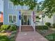 Inviting covered front porch with brick steps, patriotic flags, and manicured landscaping at the facade at 757 Shady Grove Xing, Fort Mill, SC 29708