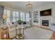 Cozy living room with a fireplace, built-in shelving, neutral colors, and lots of natural light at 757 Shady Grove Xing, Fort Mill, SC 29708