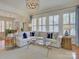 Bright living room with a fireplace, neutral colors, and large windows with shutters at 757 Shady Grove Xing, Fort Mill, SC 29708