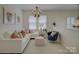 Inviting loft area features neutral colors, sofa, and ottoman creating a relaxing and comfortable space at 757 Shady Grove Xing, Fort Mill, SC 29708