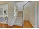 Bright and airy staircase features hardwood floors and plush carpeting, inviting you to explore the home's many levels at 757 Shady Grove Xing, Fort Mill, SC 29708