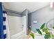 Neutral bathroom featuring a white tub/shower combo with a shower curtain and a white sink with a plant nearby at 8259 Carob Tree Ln, Charlotte, NC 28215