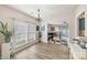 Bright dining area with hardwood floors, large windows, and an elegant chandelier at 8259 Carob Tree Ln, Charlotte, NC 28215