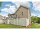 Exterior view of the property with a white fence and well-maintained lawn on a sunny day at 8259 Carob Tree Ln, Charlotte, NC 28215