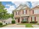 Charming two-story townhouse with tan siding, red shutters, and a neatly landscaped front yard at 8259 Carob Tree Ln, Charlotte, NC 28215