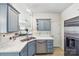 Well-appointed kitchen featuring updated appliances, grey cabinets, stainless steel sink, and white counter tops at 8259 Carob Tree Ln, Charlotte, NC 28215