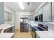 Modern kitchen with stainless steel appliances, grey cabinets, white countertops, and tile backsplash at 8259 Carob Tree Ln, Charlotte, NC 28215