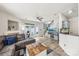 Bright living room with hardwood floors, fireplace, modern fan, and access to outdoor space at 8259 Carob Tree Ln, Charlotte, NC 28215