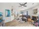 Spacious living room with hardwood floors, modern fan, fireplace, and ample seating at 8259 Carob Tree Ln, Charlotte, NC 28215