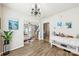 Open-concept living room with hardwood floors, seamlessly connecting to the kitchen and dining area at 8259 Carob Tree Ln, Charlotte, NC 28215