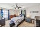 Comfortable bedroom with ceiling fan, window, matching nightstands and dressers at 8259 Carob Tree Ln, Charlotte, NC 28215
