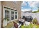 Cozy outdoor patio with a fire pit, grill, and comfortable seating, perfect for relaxing and entertaining guests at 8259 Carob Tree Ln, Charlotte, NC 28215