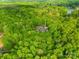 Lush greenery surrounds a beautiful home featuring mature trees, providing privacy and a connection with nature at 8451 Ridgewood Rd, Sherrills Ford, NC 28673