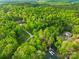 Expansive property featuring a private lake, boat dock, and a long driveway through a dense forest at 8451 Ridgewood Rd, Sherrills Ford, NC 28673