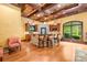 Cozy home bar featuring a stone counter, seating, custom wood cabinetry, and an arched window at 8451 Ridgewood Rd, Sherrills Ford, NC 28673