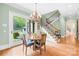 Charming dining area with staircase and view of landscaped backyard at 8451 Ridgewood Rd, Sherrills Ford, NC 28673